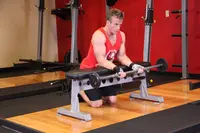 Palms-Up Barbell Wrist Curl Over A Bench